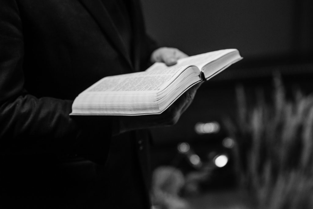 pexels photo 7317744 7317744 Grayscale close-up of a person holding an open Bible, conveying a sense of faith.